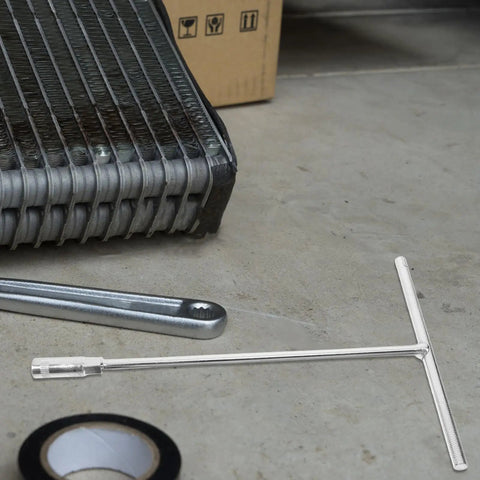 Heavy Duty T Shaped Socket Wrench 10Mm Hex Bit Driver on garage floor with radiator and tape, showing stainless steel design.