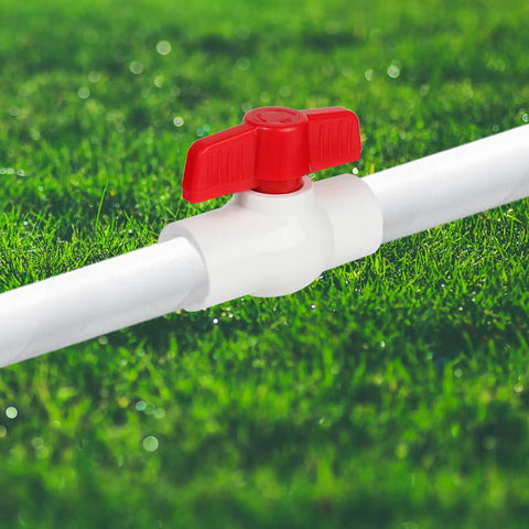 5 Pack Half Inch PVC Ball Valves For Water Shutoff, T Handle Manual On Off, installed in PVC pipe system, lush green grass background