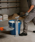 Heavy Duty Manual Loading Pump For Thick Paste And Liquid Transfer With Long Handle in use with a bucket and paint tray.
