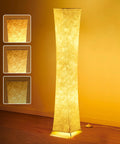 Tall Dimmable Floor Lamp With White Fabric Shade 64 Inch Standing Light Two 12W LED Bulbs 3 Brightness Levels Cozy Vibe 2700K Ambient Glow Modern Home Decor For Living Room Bedroom Kids Room glowing softly in a room.