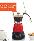 Kickstart Your Day With This Dope Compact Electric Espresso Coffee Maker Featuring A Seriously Cool Touch Handle And Versatile 3 6 Cup Capacity For Quick Perky Shots In Bold Red, with coffee brewing and cup beside.