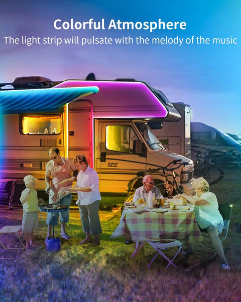 Family enjoying dinner by an RV illuminated by color changing 50ft RGB LED strip lights with Bluetooth music sync outdoors.