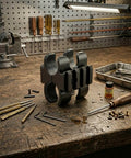 Shotgun Flashlight Mount With 12 Gauge Barrel Clamp And Picatinny Rails on workbench with tools in workshop setting