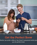 Cosori Gooseneck Electric Kettle 0.8 Liters Silver Precision Pour Over Coffee And Tea Maker With Keep Warm Feature For Barista Quality Brews Daily on kitchen counter with two people enjoying drinks.