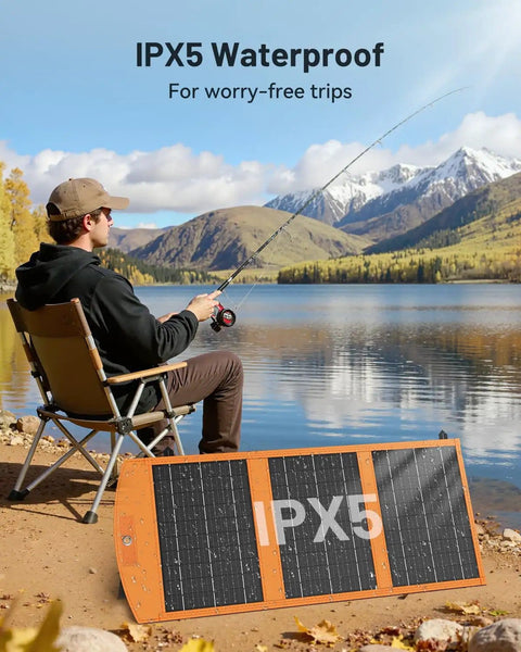 Man fishing by a lake with 30W Portable Foldable Solar Panel Charger With USB A And USB C Fast Charging, IPX5 Waterproof for Camping.