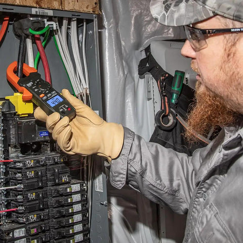 Electrician using Clamp Meter Electrical Test Kit With Auto Ranging, Measures AC Current Up To 400 Amps, Backlit Display on panel