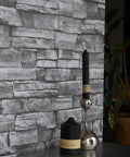 Grey Brick Wallpaper Peel And Stick 17.7 By 394 Inches Faux 3D Stone for living room wall with decorative candles.