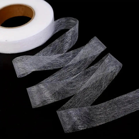One Roll No Sew Hemming Tape With Heat Fusible Bonding, Double Sided Tape for Clothing Hemming, seen unrolled on black background