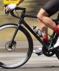 Cyclist using Ultralight Bike Water Bottle Holder For 2.75 To 3.94 Inch Bottles With Durable Cup Cage And Screw Tool during ride