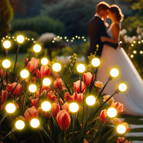 Solar Garden Lights Outdoor 4 Pack Swaying LED Fairy Lights glowing among flowers at sunset, enhancing a romantic garden atmosphere.