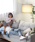 Slick Adjustable Plug In Pendant Light With Authentic Beige Linen Shade illuminates cozy living room with couple on sofa.
