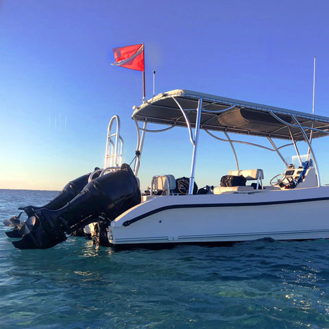 Boat with Diver Down Warning Flag With Removable Stiffening Pole 20 By 24 Inch Red And White Diving Flag in marine setting
