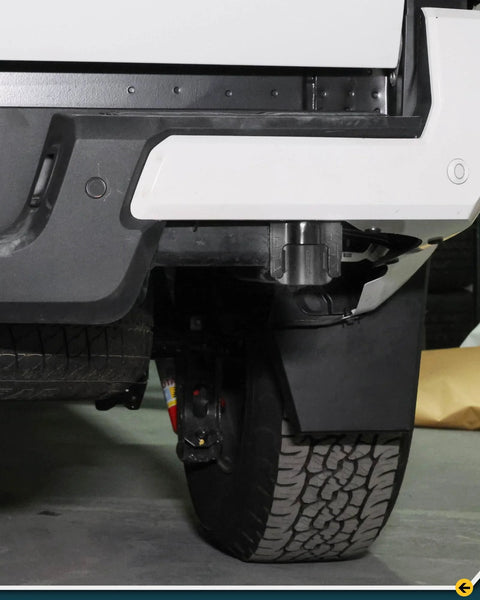 Installed pair of black rear bumper crossmember end caps for 4th-gen Toyota Tacoma