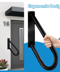 Solid Hold Wall Mount Handrail For Outdoor Steps With Non Slip Grip Safety Railing Takes Four Hundred Pounds close-up of black ergonomic design with hand grip on entryway.