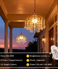 Total Game Changer Two Piece Crystal Chandelier Set Battery Powered With Zero Hassle Setup Remote Control Dimmable Rgb Pendant Lights For Living Rooms Or Covered Patios Smooth Vibes Lasting Sixty Hours hanging on porch at sunset.