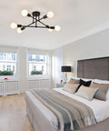 Six Lights Sputnik Style Semi Flush Mount Ceiling Chandelier In Black Finish With E26 Bulb Base in modern bedroom setting.