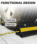 Heavy Duty Wheel Chocks For RV Trailer Camper And Truck Car That Stay Put Road Trip Ready Durable Rubber Tire Block Stopper With Rope And Bright Yellow Reflective Tape For Visibility Simple To Use And Safer Parking 4 Pack shown under a vehicle tire with yellow reflective tape and attached rope for safety.