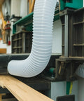 Dust Collection Kit With Heavy PVC 4 Inch Hose 10 Ft Long attached to woodworking machinery