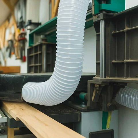 Dust Collection Kit With Heavy PVC 4 Inch Hose 10 Ft Long attached to woodworking machinery