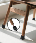 Four Pack Black Round Rubber Chair Leg Caps And Table Feet Covers Nine Sixteenth Inch Inner Diameter installed on wood chair