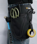 Person wearing Garden Tool Organizer Belt With Four Pockets Multi Purpose Work Apron Pouch For Gardening Florists DIY Projects And Light Plumbing Heavy Duty Tool Carrier In Black, with tools inside pockets.