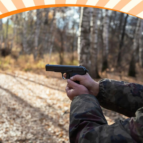 Person aiming pistol in wooded area for Two Pack High Carbon Steel Walking Tree Spinner Targets For Hunting And Shooting