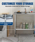 Front view of a Stainless Steel Prep Table 24x36 Inch With Adjustable Undershelf And Backsplash Built To Last Heavy Duty Commercial Kitchen Work Table For Restaurant Garage And Outdoor Use NSF Certified And Rust Resistant, shown in a storage setting.