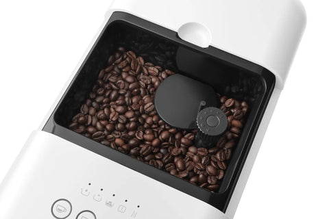 Real Deal Fully Automatic Espresso Machine With Durable Steel Burr Grinder For Bold Whole Bean Coffee And No Fuss Brewing In Sleek Matte White Kitchen Essentials showing coffee beans in grinder.
