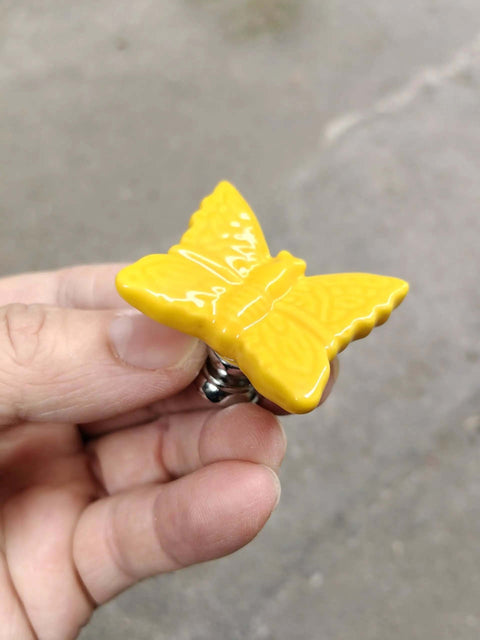 Hella Chic Yellow Ceramic Butterfly Cabinet Knobs Premium Six Piece Set shown in hand, close-up view, durable and vintage design.