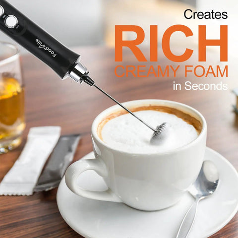 3-In-1 No-Fuss Rechargeable Milk Frother Handheld Foam Maker creating creamy foam in a cup of coffee on a table
