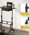 Adjustable Height Sit Stand Desk On Wheels With Drawer shown with a laptop, highlighting double design and lockable wheels, near treadmill.