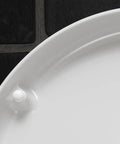Close-up of Slick Starck 3 White Toilet Seat surface showing smooth finish and hinge attachment for easy installation.