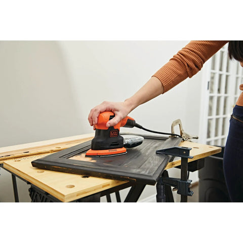 Using Compact 1.2 Amp Electric Mouse Detail Sander Handy For Tight Spaces with 14,000 Orbits Per Minute on wood surface