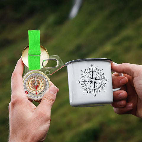 Person holding Thumb Size Directional Compass For Orienteering And Hiking, Precision Map Reading Tool For Quick Bearings and a compass mug