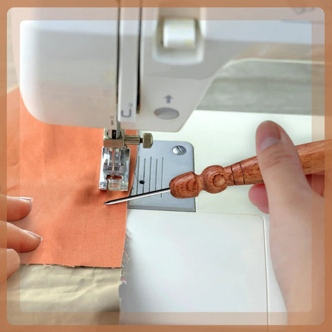 Using Go-To Stiletto and Pressing Tool for Quilting and Sewing with stainless steel tip, guiding fabric through sewing machine.