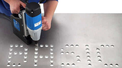 Heavy Duty Single Speed Portable Magnetic Drill With One Point Three Eight Inch Bore Eight Point Two Amp Motor Four Hundred Fifty Rpm in use on metal surface.