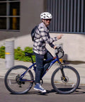 Person riding an Electric Mountain Bike For Adults With 1000W Peak Motor And 20 MPH Top Speed, 40 Mile Range on a city street.