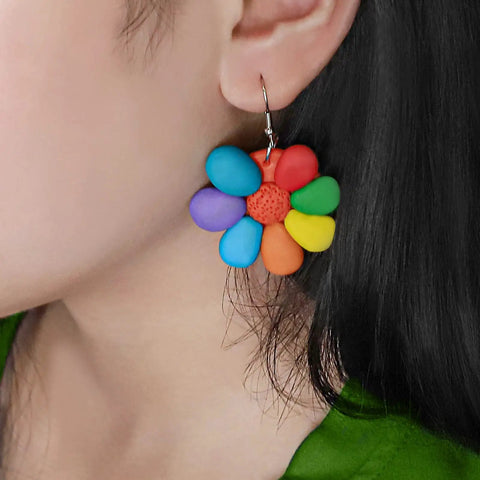 Colorful flower-shaped earrings made from Polymer Clay Starter Kit With 60 Colors For Kids And Artists, worn on ear.