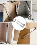 Bulletproof Six Inch Gas Struts Two Pack 30N 6.7 Lb Lift Supports for Cabinets and Closets visible installed in cabinetry.