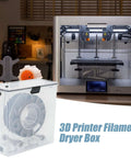 See Through Filament Dryer Box For 3D Printer with air tight seal, clear lid, displayed next to a 3D printer in a workshop setting.
