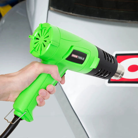 Person holding Dual Temperature 1200W Heat Gun Corded Hot Air Blower For Vinyl Wrap Paint Stripping Adhesives Nuts And Bolts Crafting And DIY Projects 482F To 842F 120V Shop Heating Tool