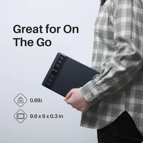 Compact Drawing Tablet With Slick Scroll Wheel And Ergonomic Stylus Delivering Sick Precision And Butter Smooth Pressure Response Perfect For Pc Artists Seeking Zero Lag Creativity And Hassle Free Setup In Sleek Black being held for portability.