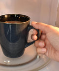 Hand placing mug in microwave oven with visible waveguide cover mica sheets pack for microwave ovens 6x6x0.02 inches high temperature 1050C mica plates replacement parts