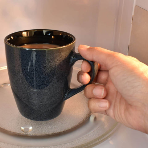 Hand placing mug in microwave oven with visible waveguide cover mica sheets pack for microwave ovens 6x6x0.02 inches high temperature 1050C mica plates replacement parts