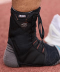 Close-up of 849 Ultra Gel Lace Up Ankle Support with Internal Gel Cushions for all day comfort, large black on athlete's foot.