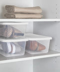Clear Plastic Storage Bins With Lids 6 Quart Stackable Organizer Boxes for closet holding shoes and linens in white shelving.