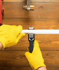 Worker uses Ratcheting Tubing Cutter 1/4 to 7/8 Inch 2 in 1 Close Quarters Pipe Cutter on white pipe