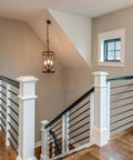 Staircase with three-light industrial chandelier, bronze finish, cylinder metal shade. Vintage vibe for dining room, lattice design.