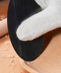 Using the Top Shelf Six Piece Cabinet Scraper And Burnisher Kit With Blue Spring Steel Blades on a wooden surface.