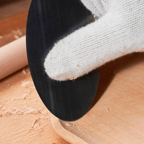 Using the Top Shelf Six Piece Cabinet Scraper And Burnisher Kit With Blue Spring Steel Blades on a wooden surface.